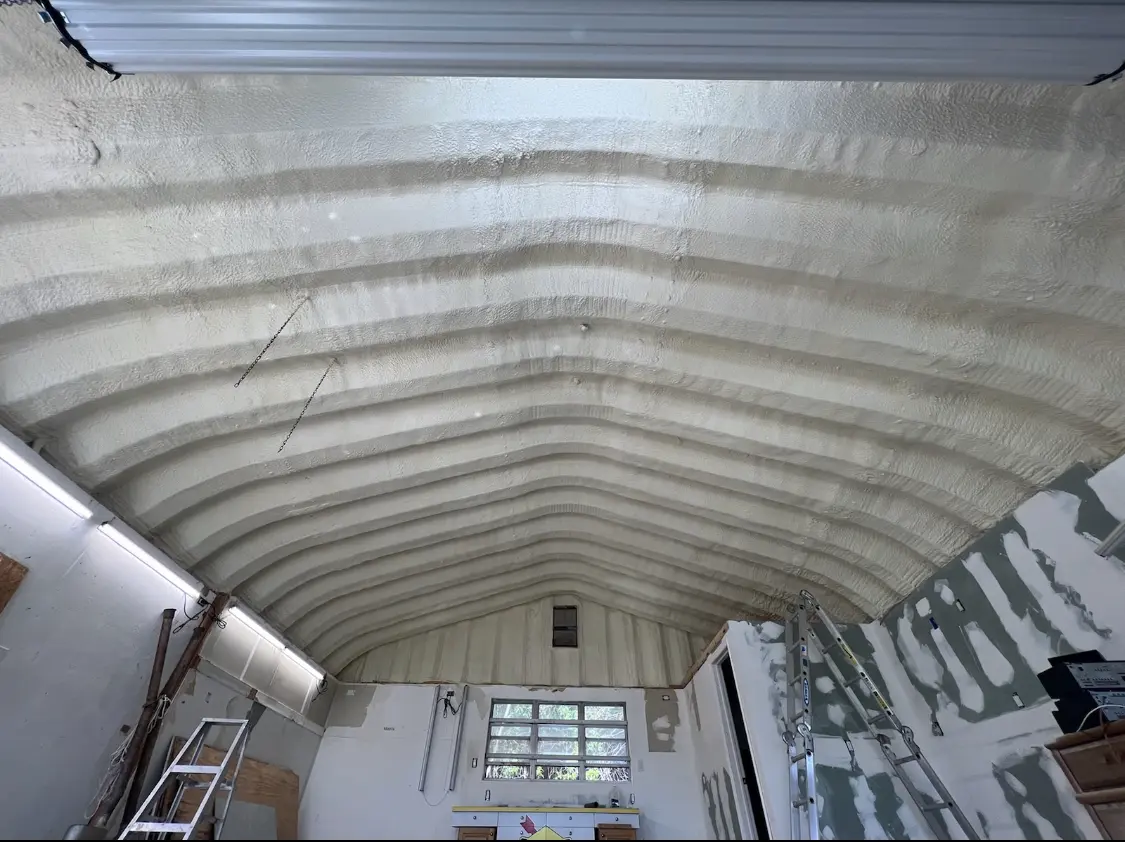 Spray polyurethane foam applied to the underside of a metal roof deck in Sitka